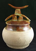 clay pot with horns on lid<empty>